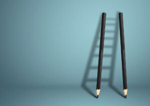 two pencils forming a ladder shadow
