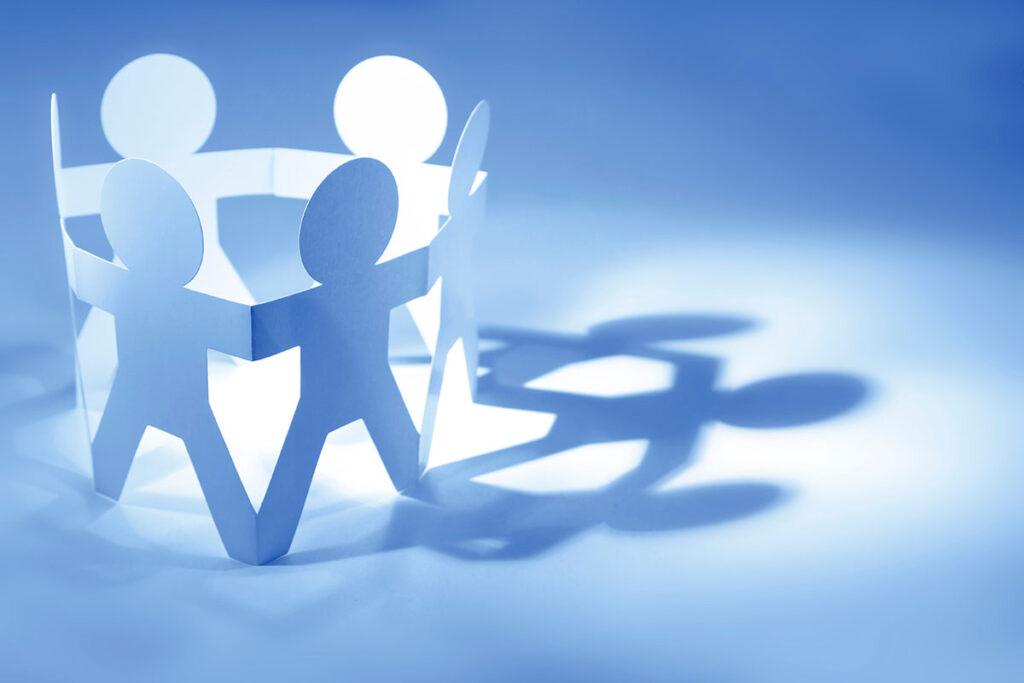 paper people cutouts holding hands
